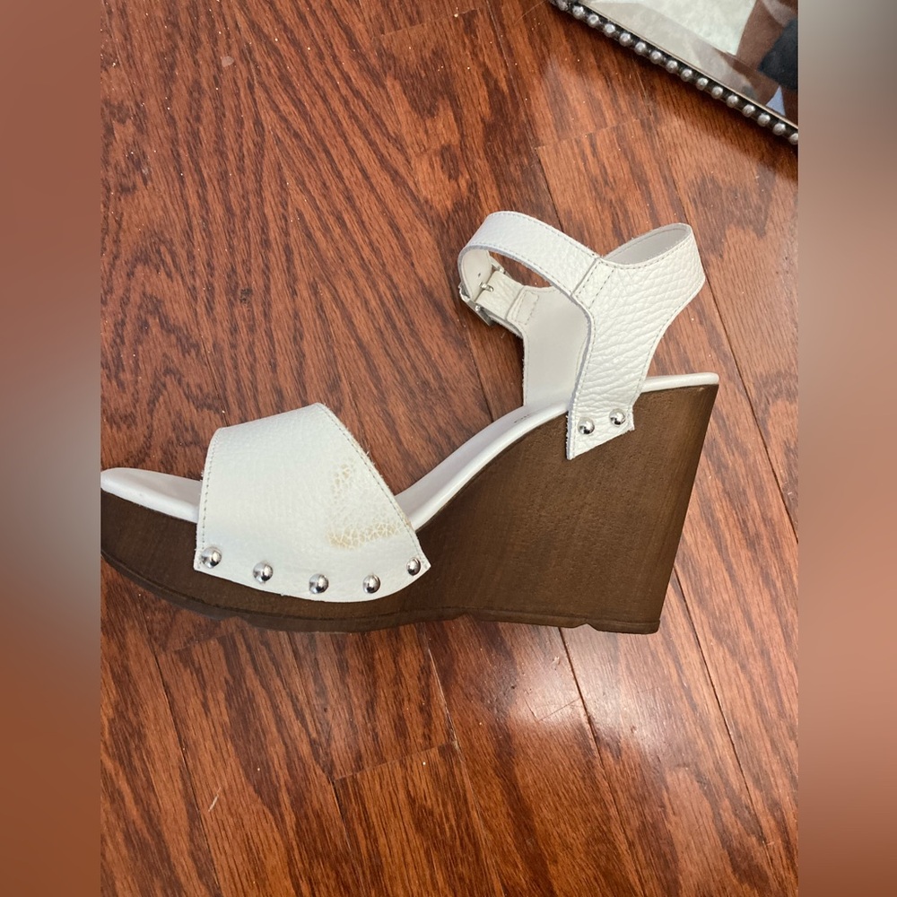 White wedge sandals with wooden heals.